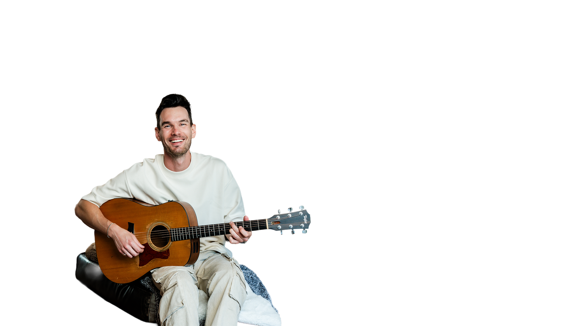 Ike Fontaine playing guitar in his studio